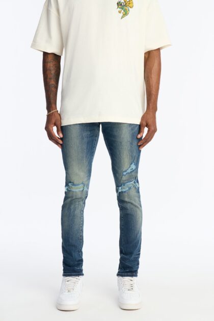 جينز سكيني ممزق بلون خفيف - أزرق متوسط